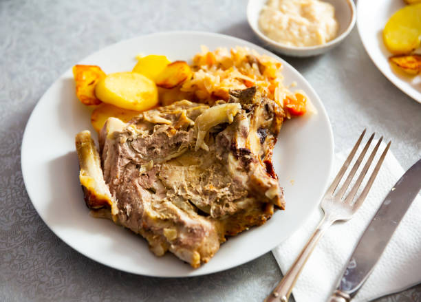 istock Pork meat with roasted potatoes and stewed cabbage 1376511671