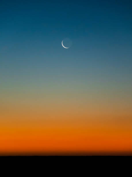 Sunrise over the dark ocean.