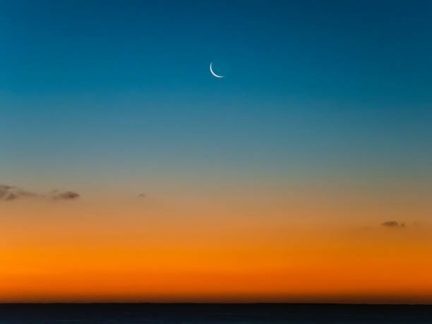 istock Crescent moon in a blue and orange sky. 1376519748