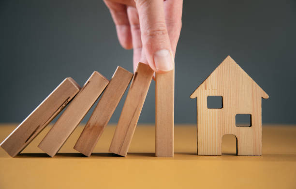 istock man holding wooden with house model 1376521522