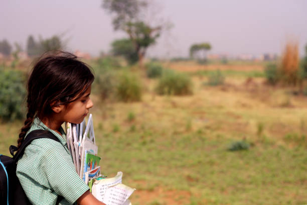 istock Poor child carrying book in hands 1376521762