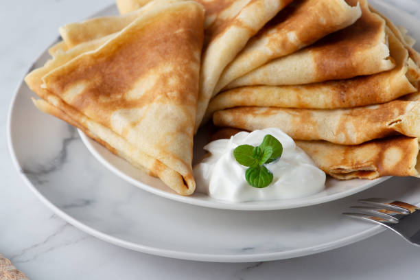 istock Stack of russian thin pancakes blini with fresh sour cream 1376528146