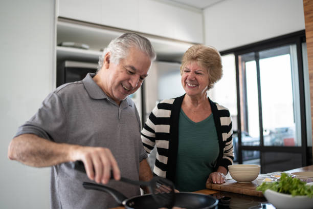 istock Senior couple cooking at home 1376528785