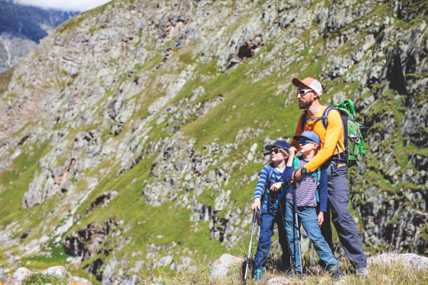 istock Father and sons trekking in mountains 1376529191