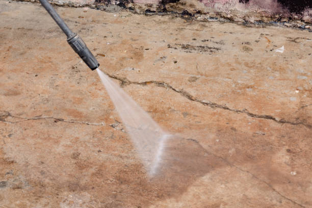 istock Worker cleaning dirty floor with high pressure washer 1376529194