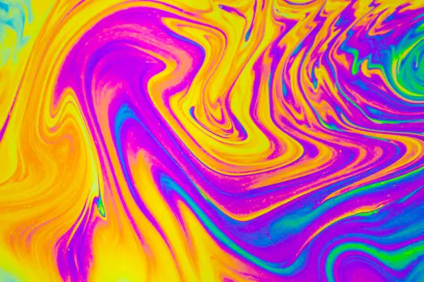 Photo of Rainbow colors. Psychedelic multi colored patterns background. Photo macro shot of soap bubbles