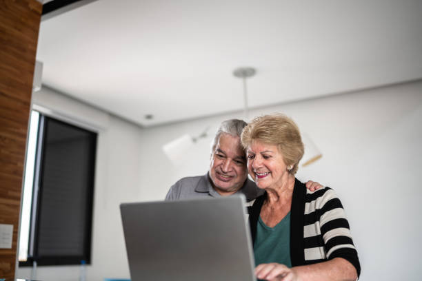 istock Senior couple using laptop at home 1376529835