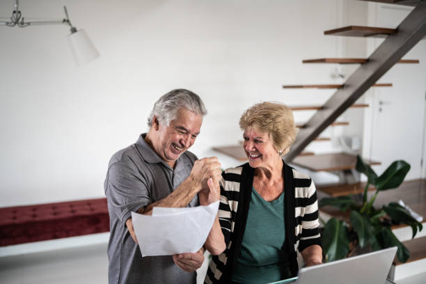 istock Senior couple doing home finances and celebrating 1376529846