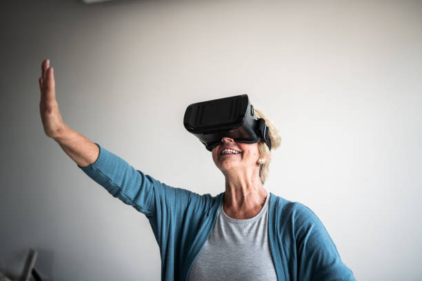 istock Happy senior woman wearing virtual reality simulator 1376529906