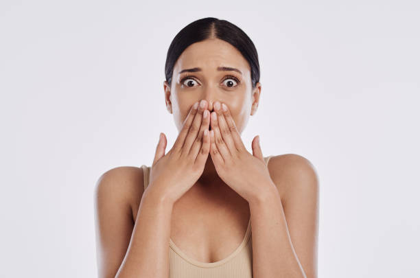 istock Shot of a woman looking shocked while standing against a studio background 1376552116