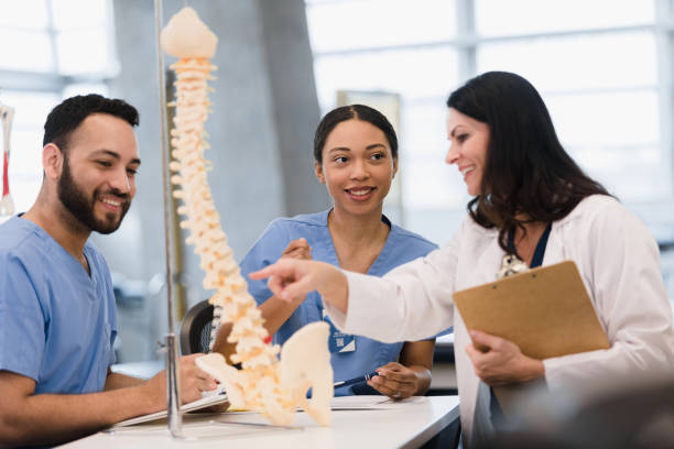 istock Students learn about human spine from female medical school professor 1376575396