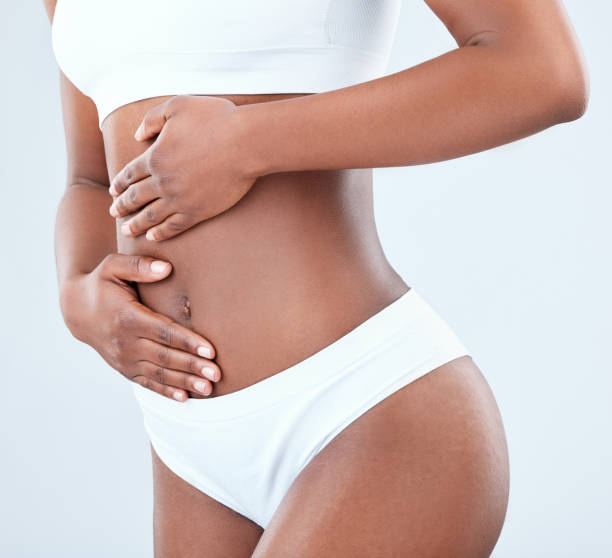 istock Woman in undergarments against light blue background 1376579710