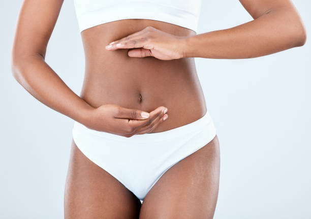 istock Woman in undergarments against light blue background 1376579715