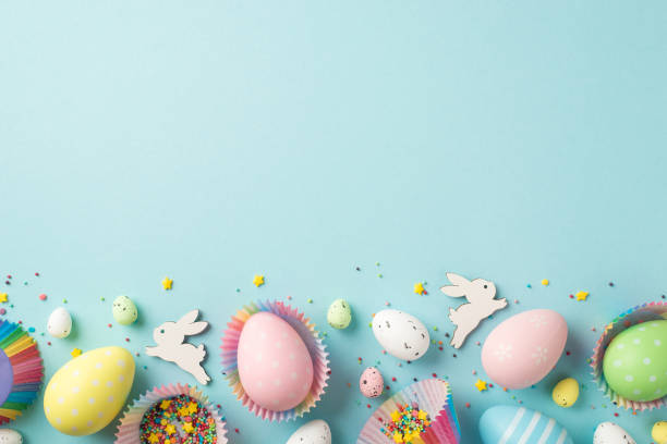 istock Top view photo of easter decorations easter bunnies multicolored easter eggs in paper baking molds and confectionery topping on isolated pastel blue background with copyspace 1376602066