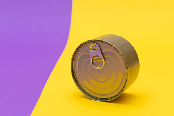 istock Unopened Tin Can with Blank Edge on Split Yellow and Violet Background 1376604758