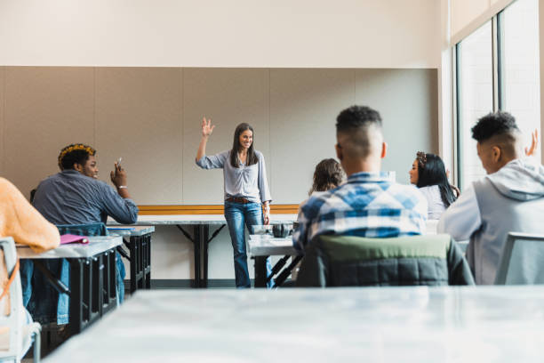 istock Rear view of classroom as teacher asks for volunteers 1376611809