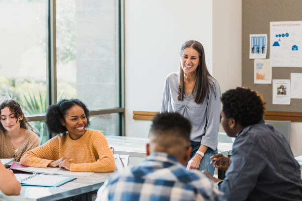 istock Teacher and teen students throw ideas around for project 1376611827