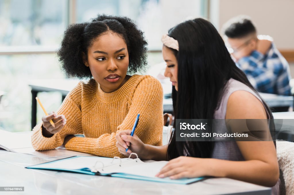Teen girls brainstorm for class assignment Two teenage girls brainstorm ideas for their class assignment. Teenagers Only Stock Photo