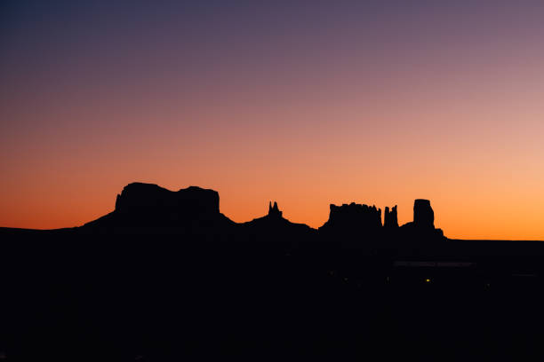 Watching the silhouettes of monument valley as the sun glows from behind them