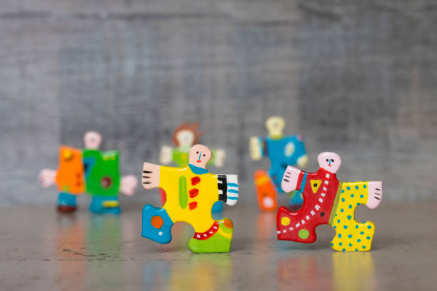 Hand painted jigsaw puzzle piece figures stock photo