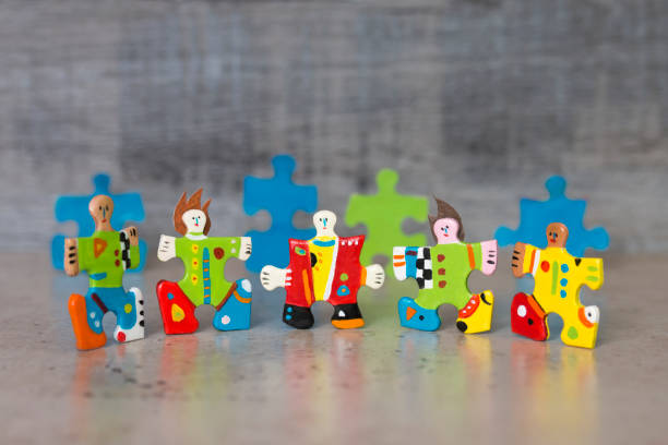 Hand painted jigsaw puzzle piece figures stock photo