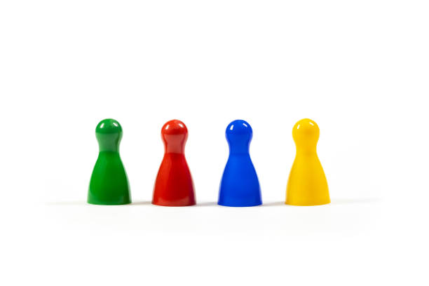 istock Row of 4 different diverse multi colored game pieces representing a diverse group of people, corporate business company teamwork, diversity and togetherness simple metaphor, abstract concept, nobody 1376660377