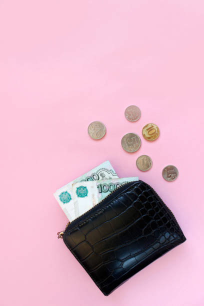 istock Russian rubles in the wallet on a pink background. Thousand notes and various coins. Place for text. Copy space. background for economic news. 1376664797