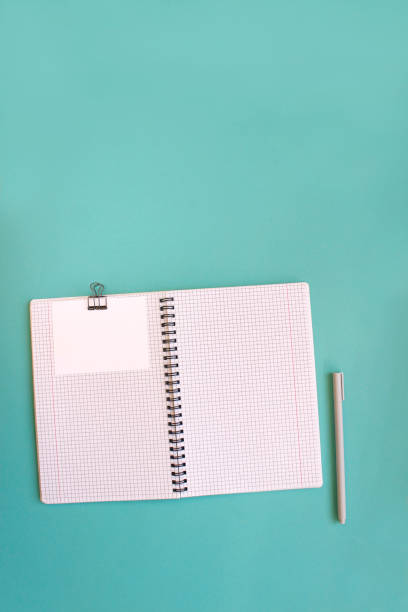 istock Blank notebook for writing on spirals on a blue background, flat lay, the end of motivation, business, building goals with negative industrial space and copy space 1376680247