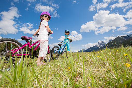 8/9 years old children riding bicycle at Banff National Park, Canada.