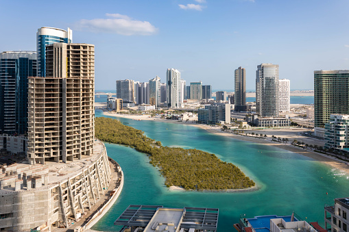 Aerial view of Reem Island in Abu Dhabi with mangrove trees and modern skyscrapers