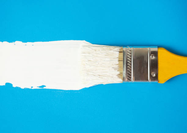istock brush with white paint draws space for text on blue background 1376702040