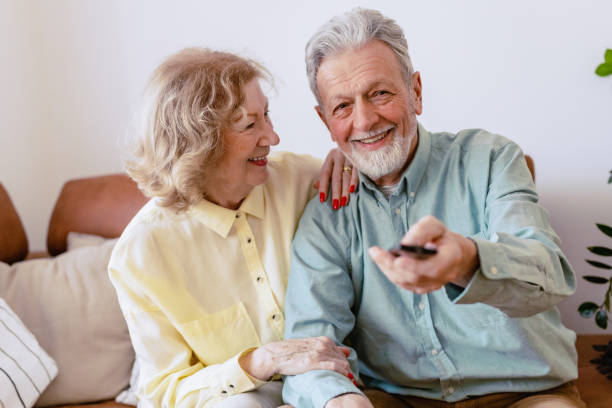 istock Senior couple at home watching TV 1376711384