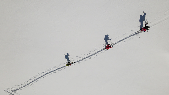 Aerial view of ski mountaineers moving up a slope