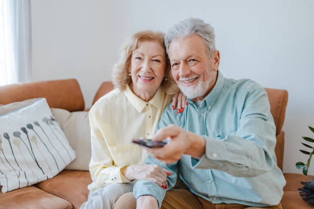 istock Senior couple at home watching TV 1376719897