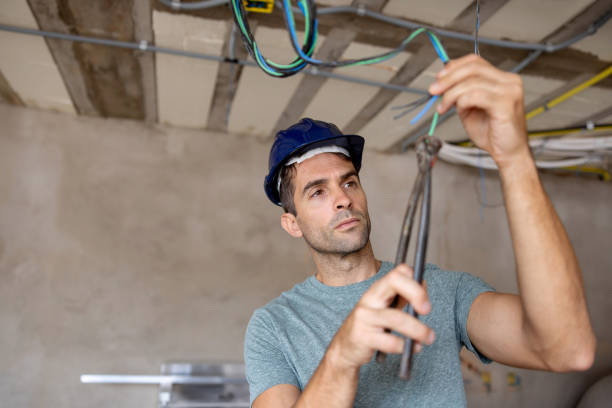istock Electrician working at a construction site installing wires 1376721532