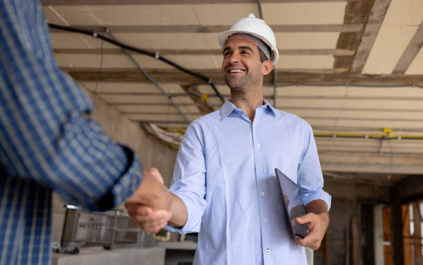 istock Happy civil engineer hanshaking the had of a construction worker 1376721542
