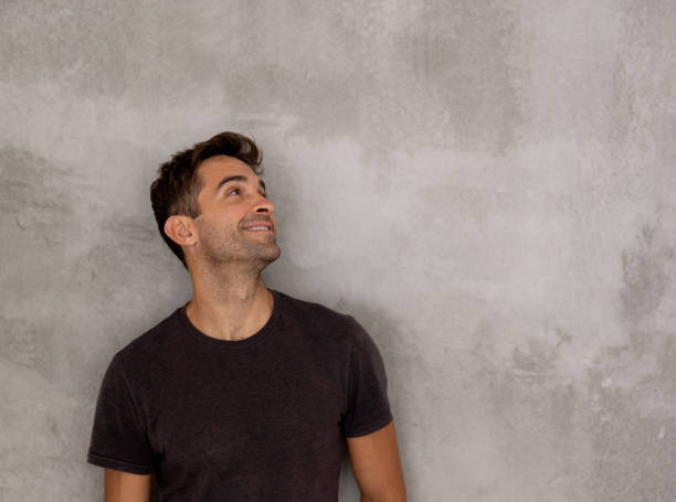 istock Thoughtful man leaning against a wall 1376721595