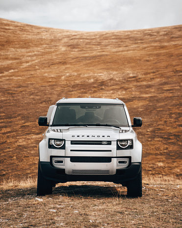 Campo Imperatore, Italy - September 26, 2020 : The New Land Rover Defender 2020 is parked on a dry landscape