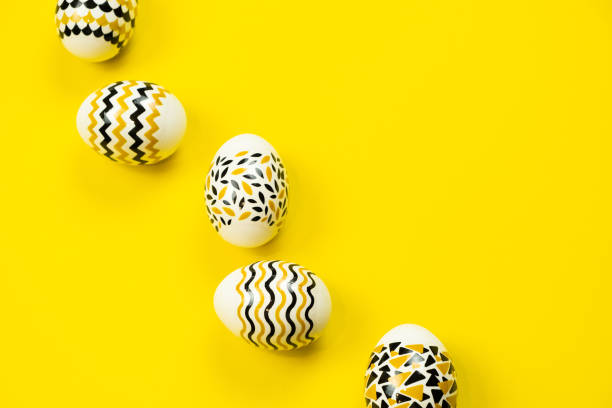 istock White eggs with a geometric gold and black pattern on a white background. Copy space. Flat lay. 1376841251
