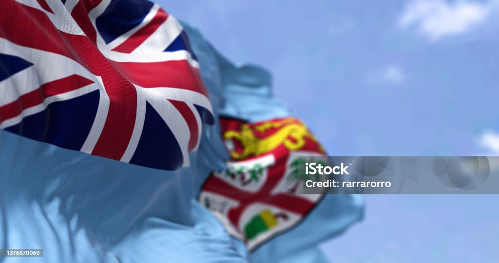 Detail of the national flag of FIji waving in the wind on a clear day Detail of the national flag of FIji waving in the wind on a clear day. Fiji is an island country in Melanesia, part of Oceania in the South Pacific Ocean. Selective focus. Seamless slow motion Archipelago Stock Photo