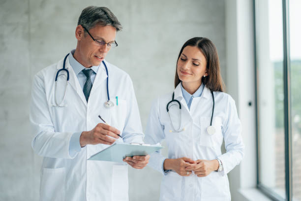 istock Two healthcare workers talking at hospital 1376878846