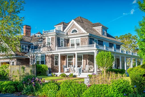 Traditional Large House with wood shingles in Chatham, Cape Cod, Massachusetts, USA on a sunny day.