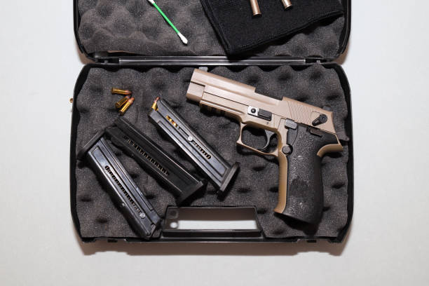 istock A gun and bullets stored in a black case on a white background 1376931568