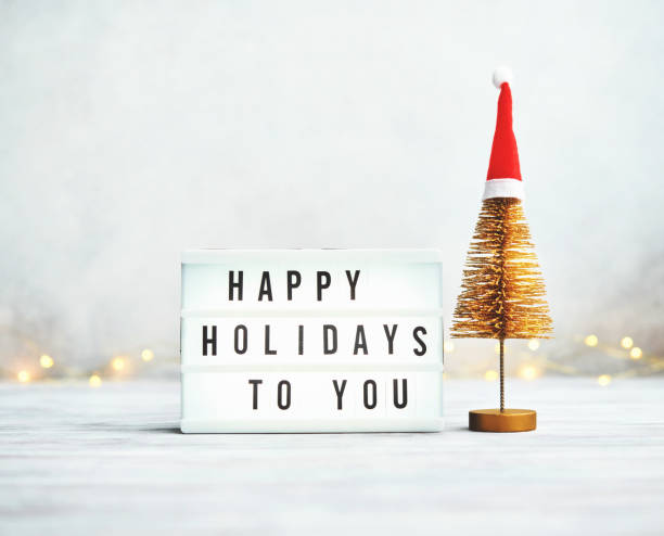 istock Christmas arrangement with tinsel Christmas tree and Happy Holidays message 1377002041