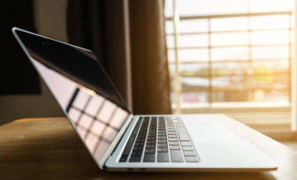 istock Working on keyboard modern laptop on top table. Business and working concept. 1377003635