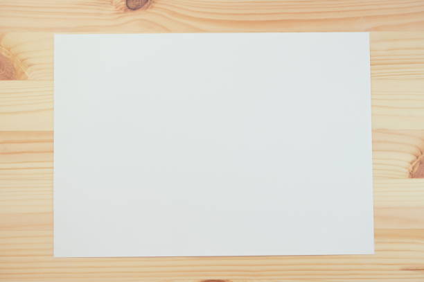 istock white paper on wood table 1377020584