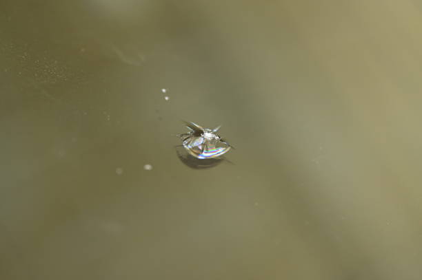 istock broken windshield of vehicle, blur background 1377021152