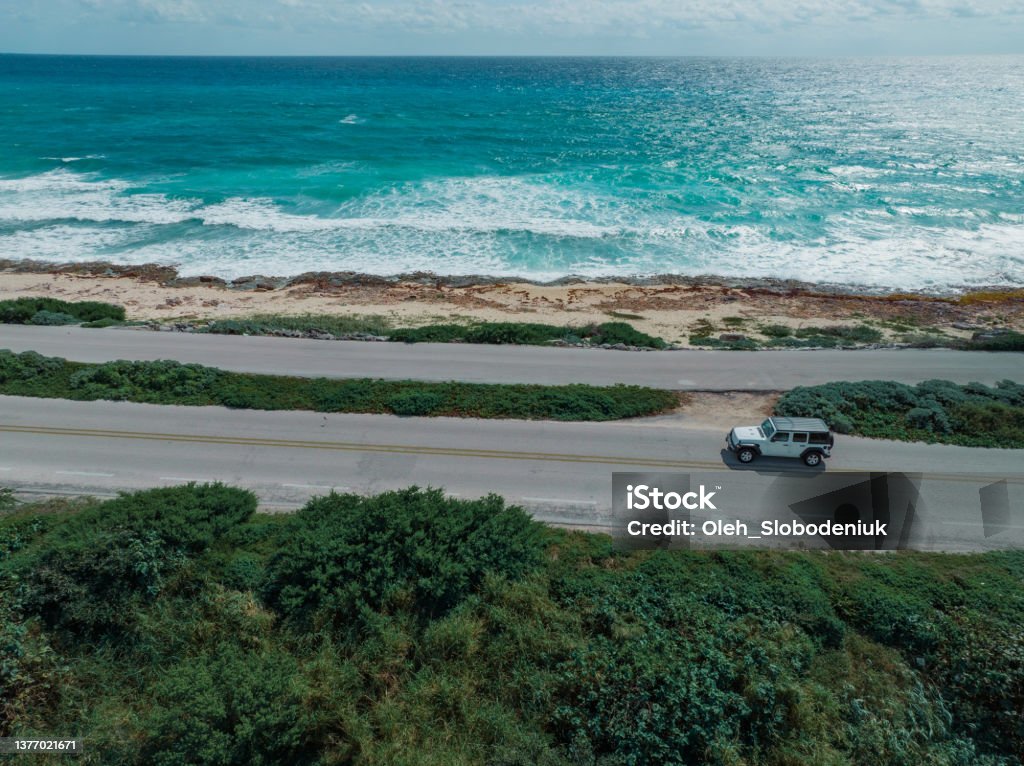 Aerial view of  car on road on Cozumel Island near Playa del Carmen at sunset Scenic aerial view of  car on road on Cozumel Island near Playa del Carmen at sunset Cozumel Stock Photo