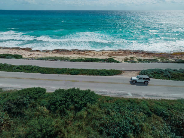 Aerial view of  car on road on Cozumel Island near Playa del Carmen at sunset Scenic aerial view of  car on road on Cozumel Island near Playa del Carmen at sunset cozumel photos stock pictures, royalty-free photos & images