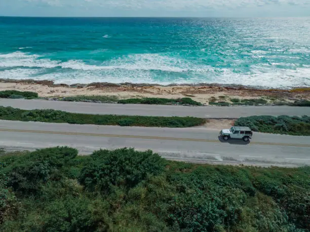 Scenic aerial view of  car on road on Cozumel Island near Playa del Carmen at sunset